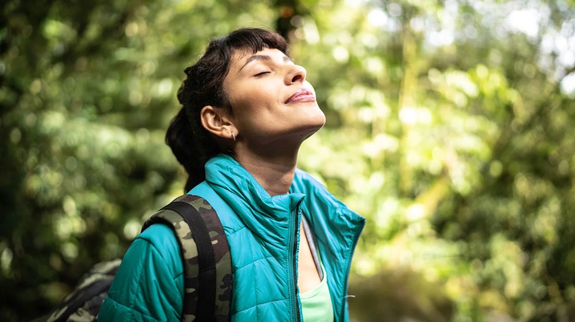 A person enjoying a calm moment outdoors in nature
